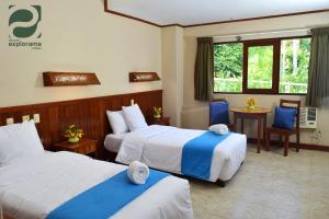 En eller flere senge i et værelse på Ceiba Tops