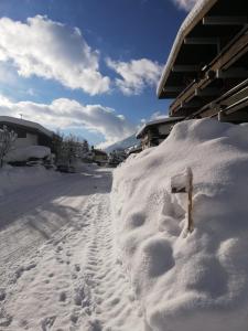 a pile of snow next to a house at Kitzdesign in Kirchberg in Kirchberg in Tirol