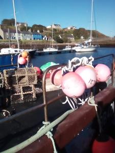 a boat with a bunch of equipment on the deck at Sea Song, Selkie House in Helmsdale