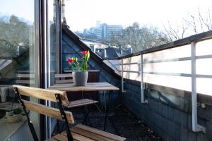 a table and a chair on a balcony with a window at Apartments an der Universität in Wuppertal