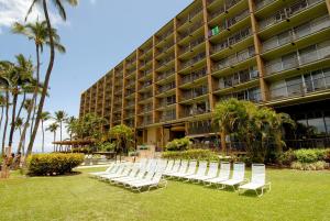 a row of white chairs in front of a hotel at Mana Kai Maui - Official Onsite Rental Company in Wailea