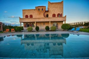 a house with a pool in front of it at Villa Al Jaouhara in Essaouira