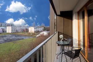 a balcony with a table and chairs and a view at Passion4Cracow in Kraków