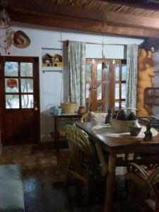 a dining room with a wooden table with chairs at Hotel de Campo Oeste Paraíso in La Ciénaga