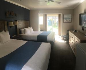 En eller flere senge i et værelse på Rio Sands Hotel