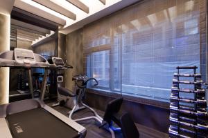 a gym with exercise equipment and a large window at The Tango Hotel Taipei ChangAn in Taipei