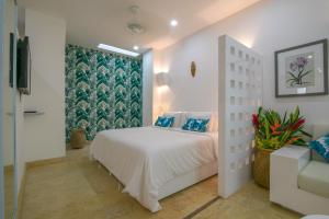 a bedroom with a white bed and a window at El Cactus Luxury Apartments in Historic Center in Santa Marta