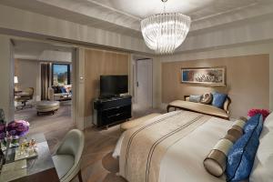 a bedroom with a large bed and a living room at Mandarin Oriental, Taipei in Taipei