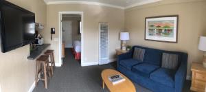 a living room with a blue couch and a tv at Rio Sands Vacation Rentals in Aptos