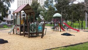 a playground in a park with two play equipment at ReadySet Apartments on Altona in Melbourne