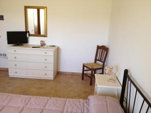 a bedroom with a bed and a dresser and a mirror at La Collina Dei Ciliegi in Camerino