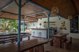 a kitchen with wooden tables and a bar in a room at Sanur House in Sanur