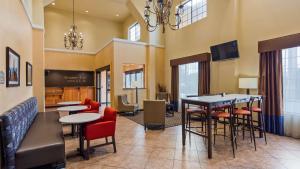 a lobby with tables and chairs and a waiting room at Best Western Windsor Pointe Hotel & Suites - AT&T Center in San Antonio