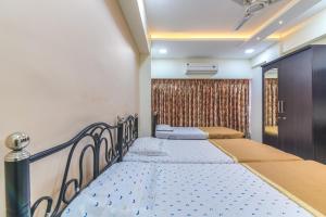 a bedroom with two beds in a room at Hotel Nest Inn in Mumbai