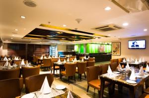
a restaurant with tables, chairs, and tables at Platinum Grand in Dhaka
