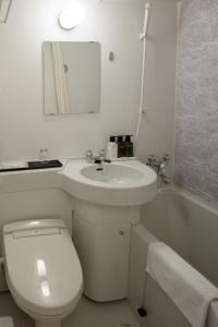 a bathroom with a toilet and a sink and a tub at Center Hotel Narita2 R51 in Narita