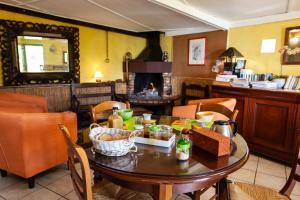 a dining room with a wooden table and chairs at Relais du Volcan in La Plaine des Cafres