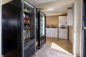 a room with a refrigerator with drinks in it at Rodeway Inn Near Hall of Fame in Canton