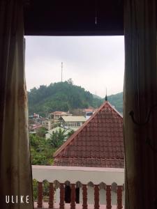 a view of a mountain from a window at Vân Anh Guesthouse in Yên Bái