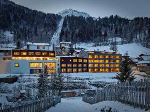 a hotel in the mountains in the snow at Aktiv-Hotel Sarotla in Brand