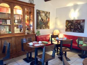a dining room with two tables and chairs at Le Maset en Camargue in Saintes-Maries-de-la-Mer