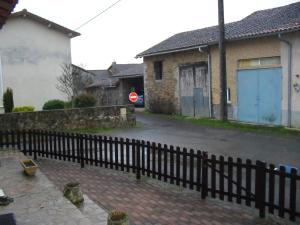 une clôture en face d'une rue avec des maisons dans l'établissement l'ancienne épicerie, à Oradour-sur-Glane