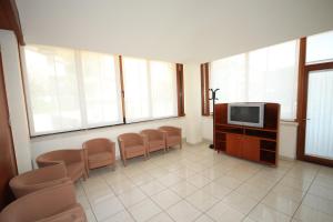 a waiting room with a tv and some chairs at Albergo San Michele in San Giovanni Rotondo