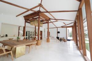 a dining room with a wooden table and chairs at The Apartments Ubud in Ubud +56 photos
