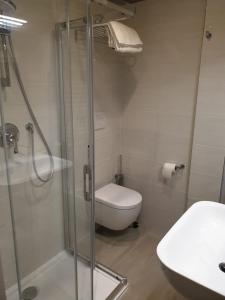 a bathroom with a shower and a toilet and a sink at Hotel Altieri in Favaro Veneto