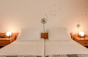 En eller flere senge i et værelse på Hotel Barba