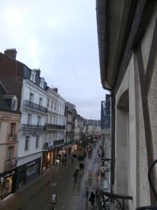 a view of a city street with people and buildings at au Claire de lune in Dieppe
