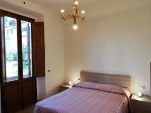 a bedroom with a bed and a chandelier at Prato Barone a Firenze in Florence