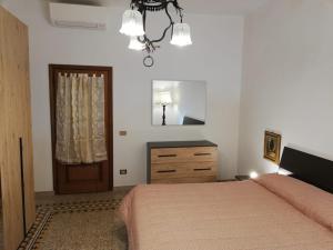 a bedroom with a bed and a dresser and a door at Prato Barone a Firenze in Florence