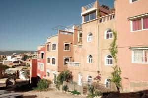 a group of buildings with a city in the background at Dar Océana in Tamraght Oufella