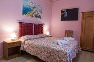 Postel nebo postele na pokoji v ubytování BB La Bella Addormentata e il Principe Calaf