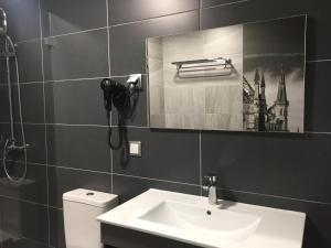 a bathroom with a sink and a mirror and a toilet at PinoyHouse Fatima in Fátima +68 photos