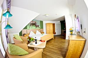 un soggiorno con divano e tavolo di Landhotel Jagdschloss a Windelsbach