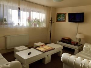 a living room with a couch and a table at Pensiunea Orizont in Poiana Brasov