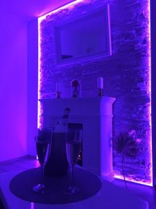 a room with two wine glasses and a fireplace at Infinity Two in Waldbrunn