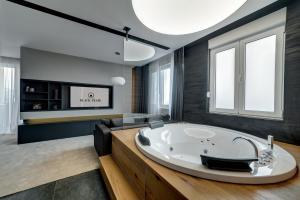 a bathroom with a large tub in a room at Black Pearl Luxury Suites in Belgrade