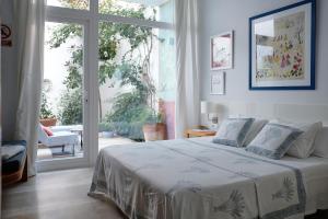 a bedroom with a bed and a large window at Casa Limon in Sanlúcar de Barrameda