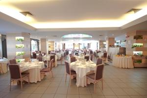 a dining room with white tables and chairs and tablesearcher at Albergo San Michele in San Giovanni Rotondo +36 photos