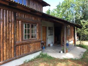 a log cabin with the front door open at Toad Tree Cabins in Sodwana Bay