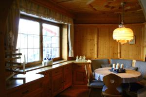 a dining room with a table and a window at Florentiner Haus in Kiefersfelden