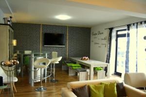 a living room with a couch and a table at Florentiner Haus in Kiefersfelden