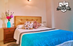 מיטה או מיטות בחדר ב-Hostal Restaurante La Niña