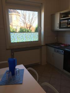 a kitchen with a table and a window in a kitchen at Ferienwohnung Lortz in Cuxhaven