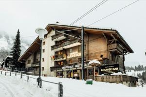 a large building in the snow in front at Hotel Maya Caprice in Wengen