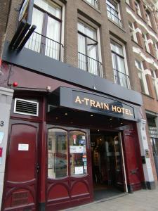a red brick building with a sign on the side of it at A-Train Hotel in Amsterdam