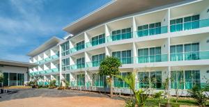 an exterior view of a large white building at The Tree Samui in Bophut 